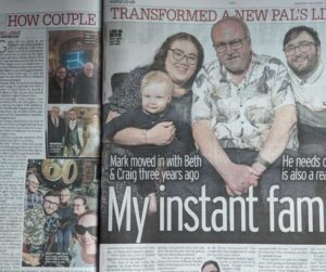 An image of the double page spread in The Daily Mirror. The headline reads 'My instant family' and the main photograph sees Craig, Beth, Mark and Craig and Beth's baby son sat on the couch together smiling at the camera